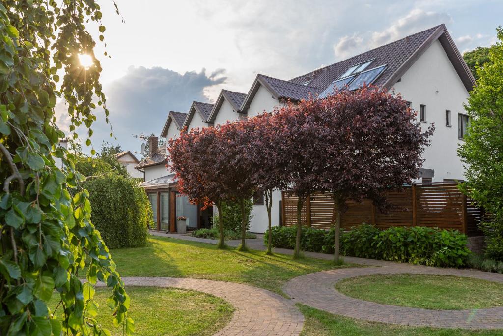 a house with a pathway in front of it at Villa Madre Golf & Family in Wisełka