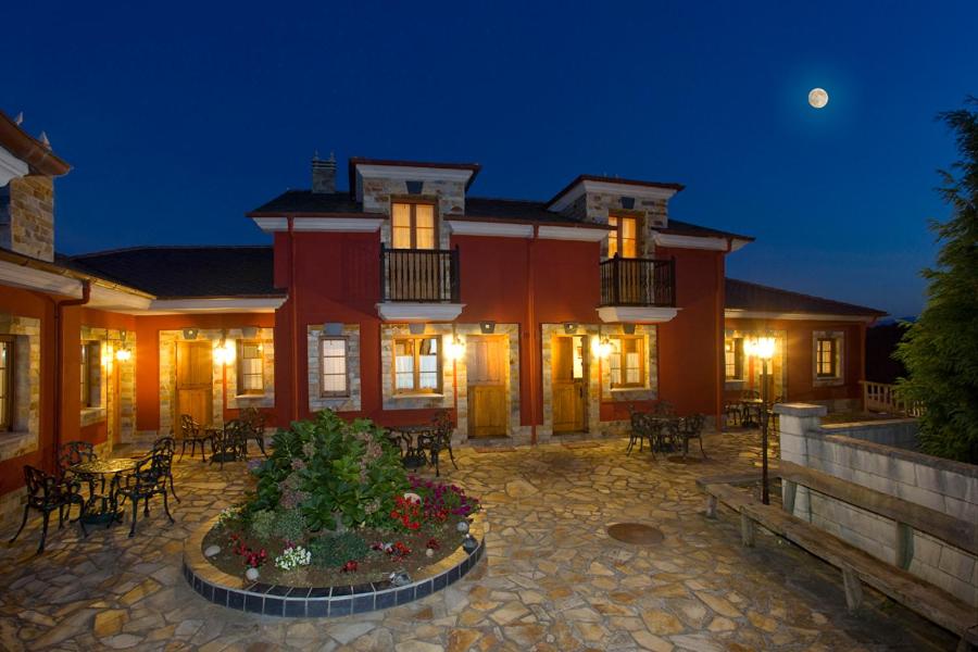 a large house with a patio at night at Apartamentos Porcia in Tapia de Casariego