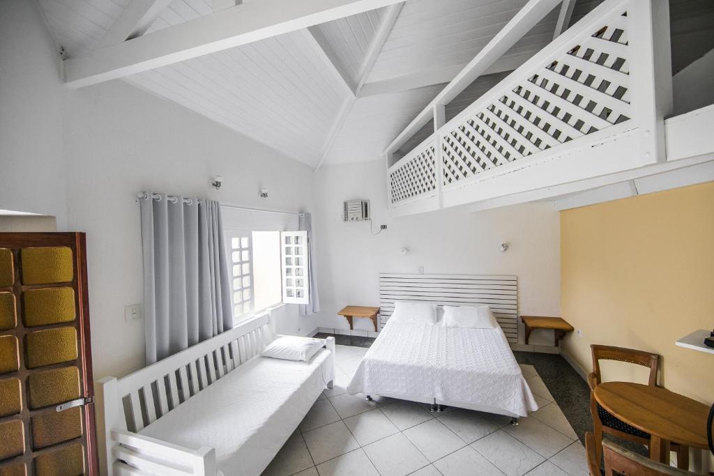 Cama ou camas em um quarto em Pousada Passeio Brig Maresias
