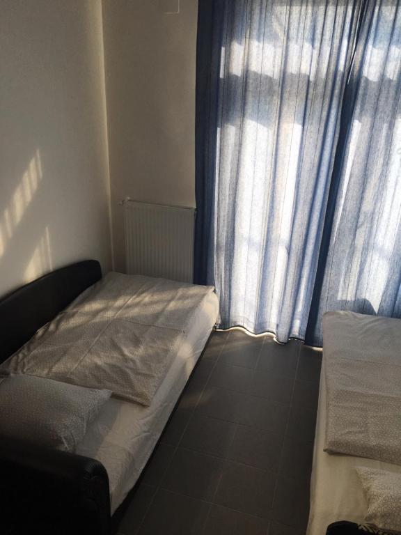 Postel nebo postele na pokoji v ubytování Tocc Apartman