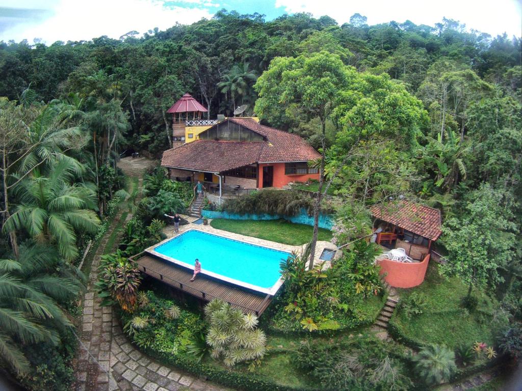 an aerial view of a house with a swimming pool at Pousada Casa Milà in Ubatuba