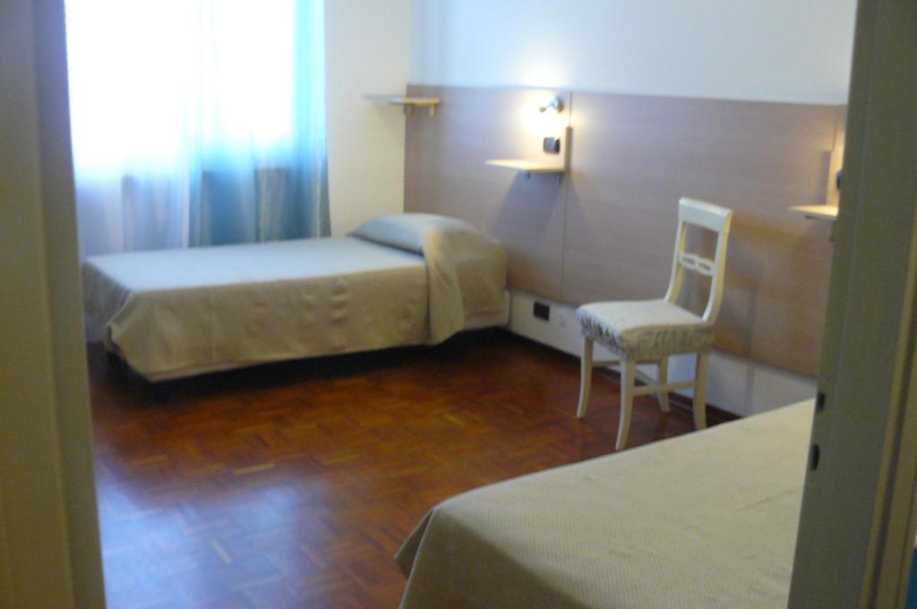 Postel nebo postele na pokoji v ubytování Hotel Vittoriano