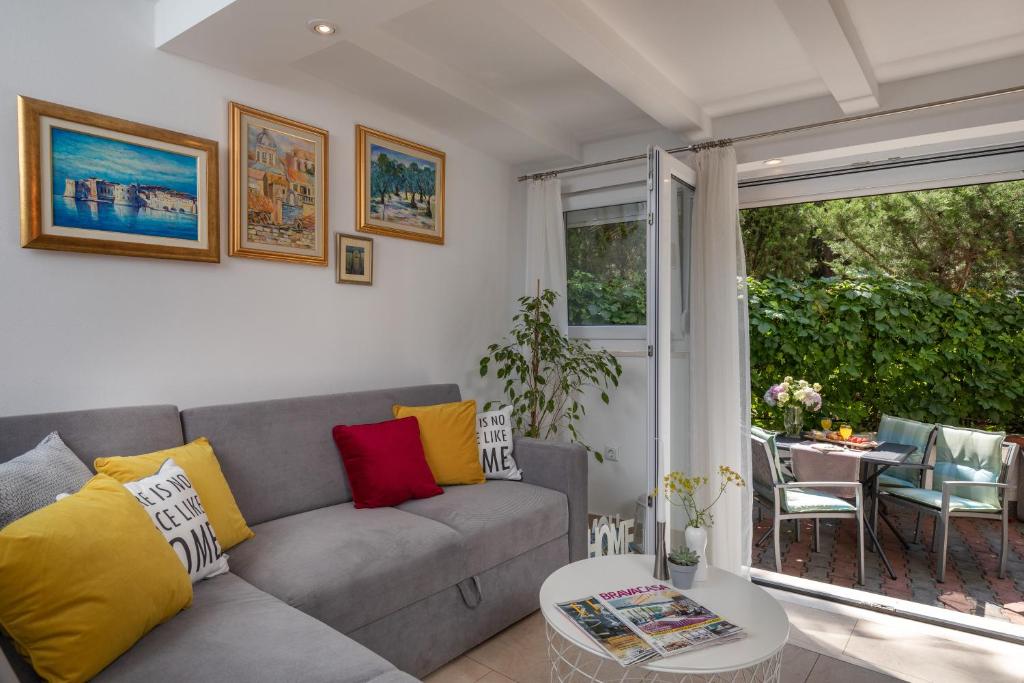 a living room with a couch and a table at ANAMARIJA APARTMAN in Dubrovnik