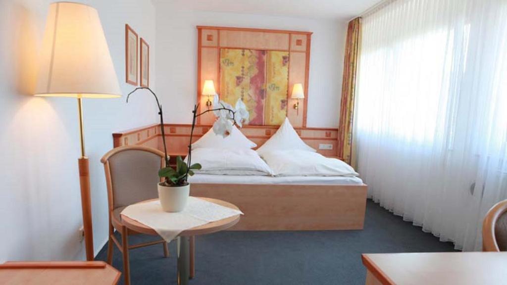 Postel nebo postele na pokoji v ubytování Hotel Wetterau - Self-Check-In