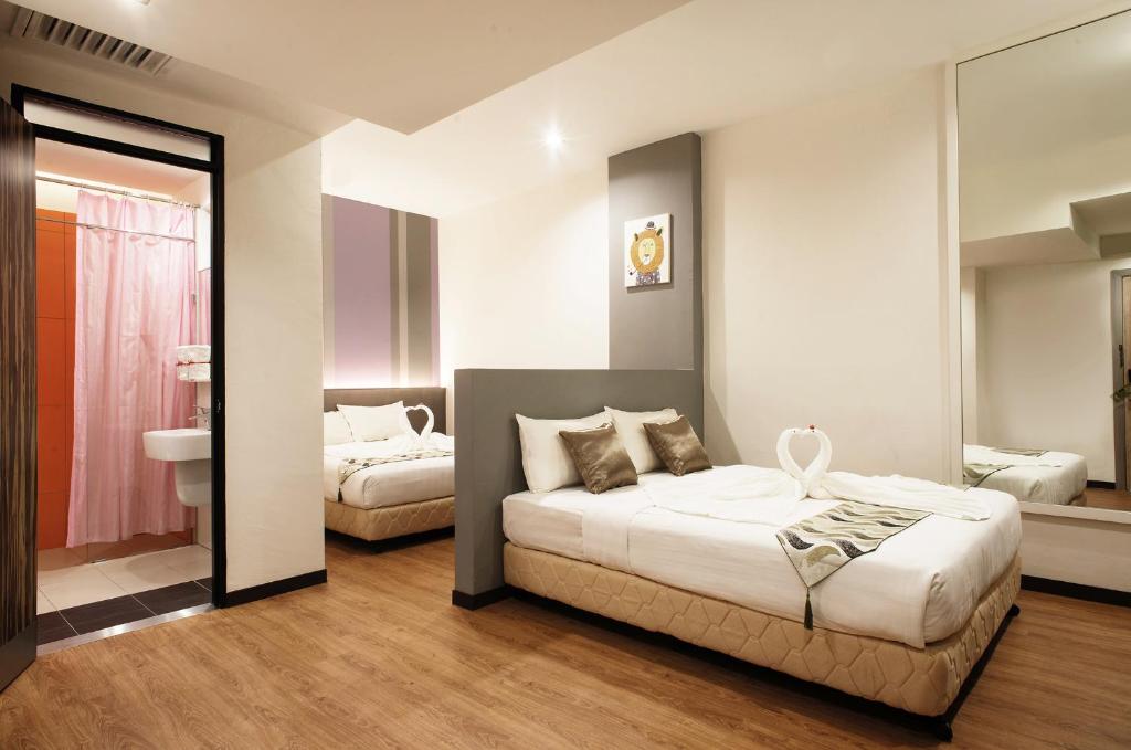 Postel nebo postele na pokoji v ubytování Yan Hotel