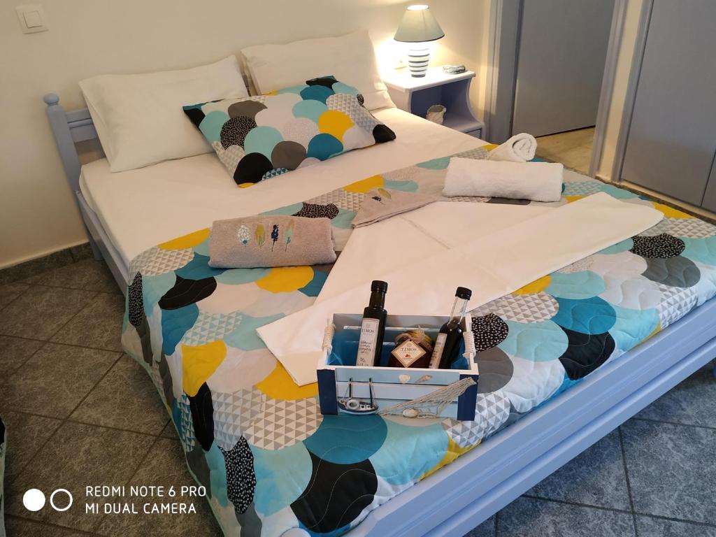 a bed with a box of wine bottles on it at Timos Studios in Romanón