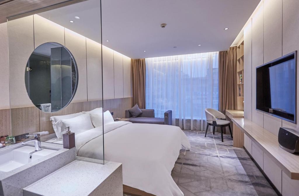 TV a/nebo společenská místnost v ubytování Paco Hotel Guangzhou Baiyun Airport Liantang Metro
