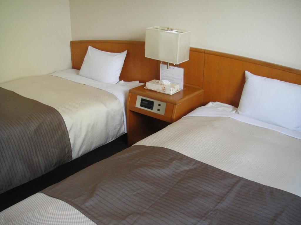 Postel nebo postele na pokoji v ubytování Hotel New Shizuoka