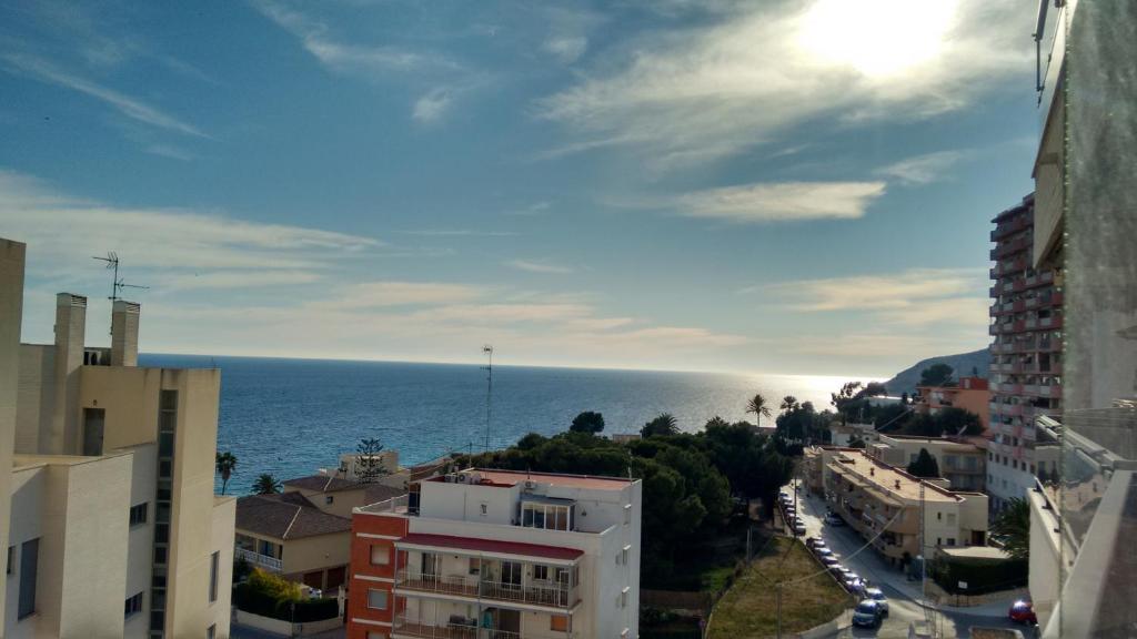 a view of the ocean from a city with buildings at Plaza Mayor 2 bedroom Apartment in Calpe