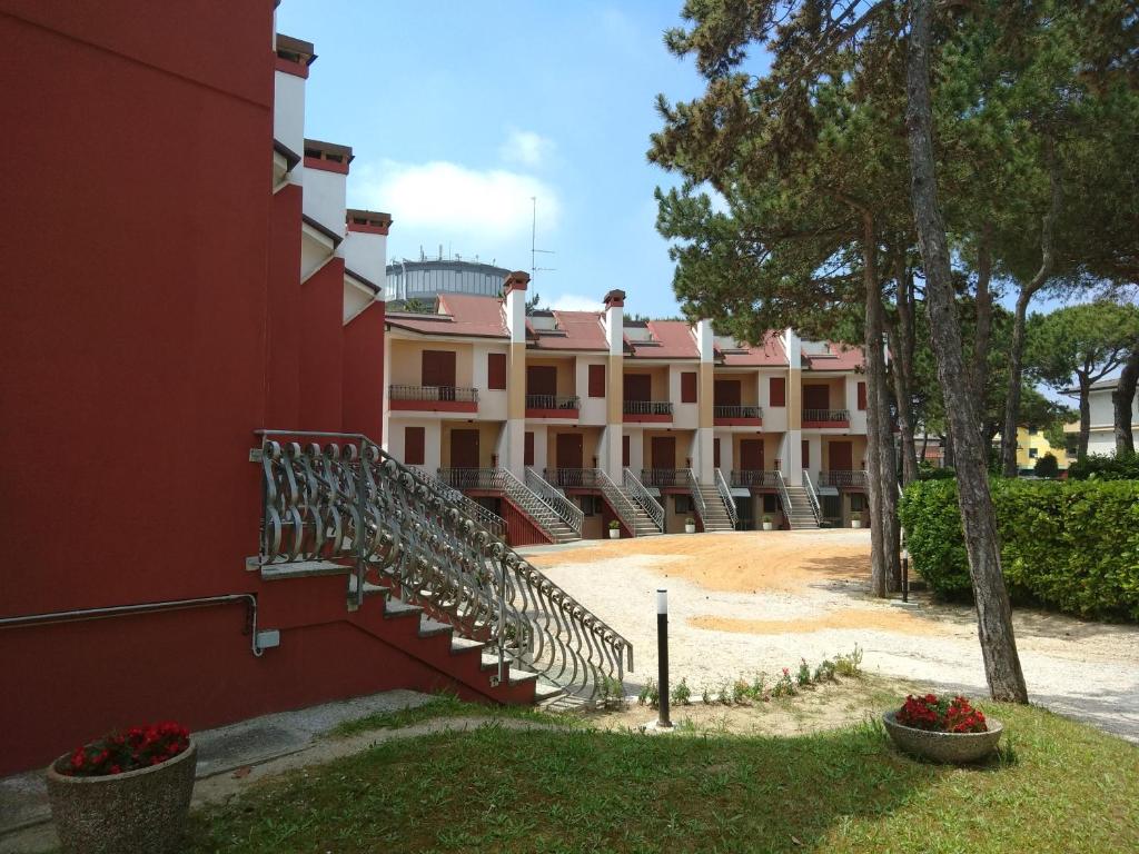 a building with stairs in front of it at Casa Bianca Village Apartments in Lignano Sabbiadoro