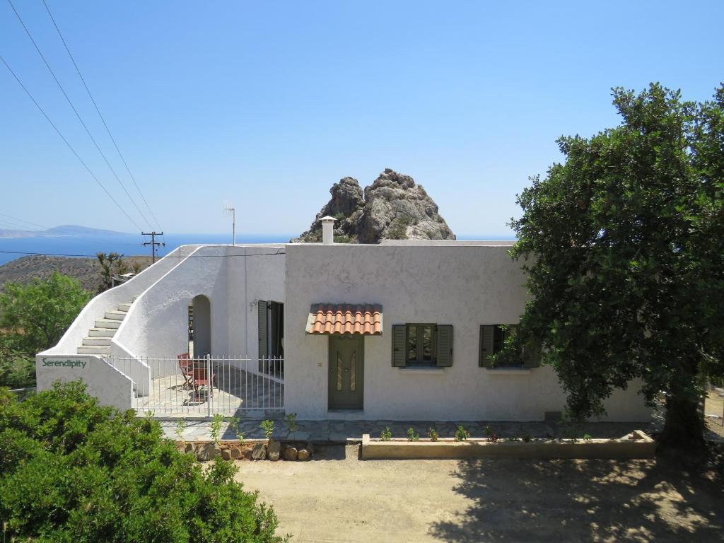 a white house with a rock on top of it at Serendipity Crete in Agia Galini