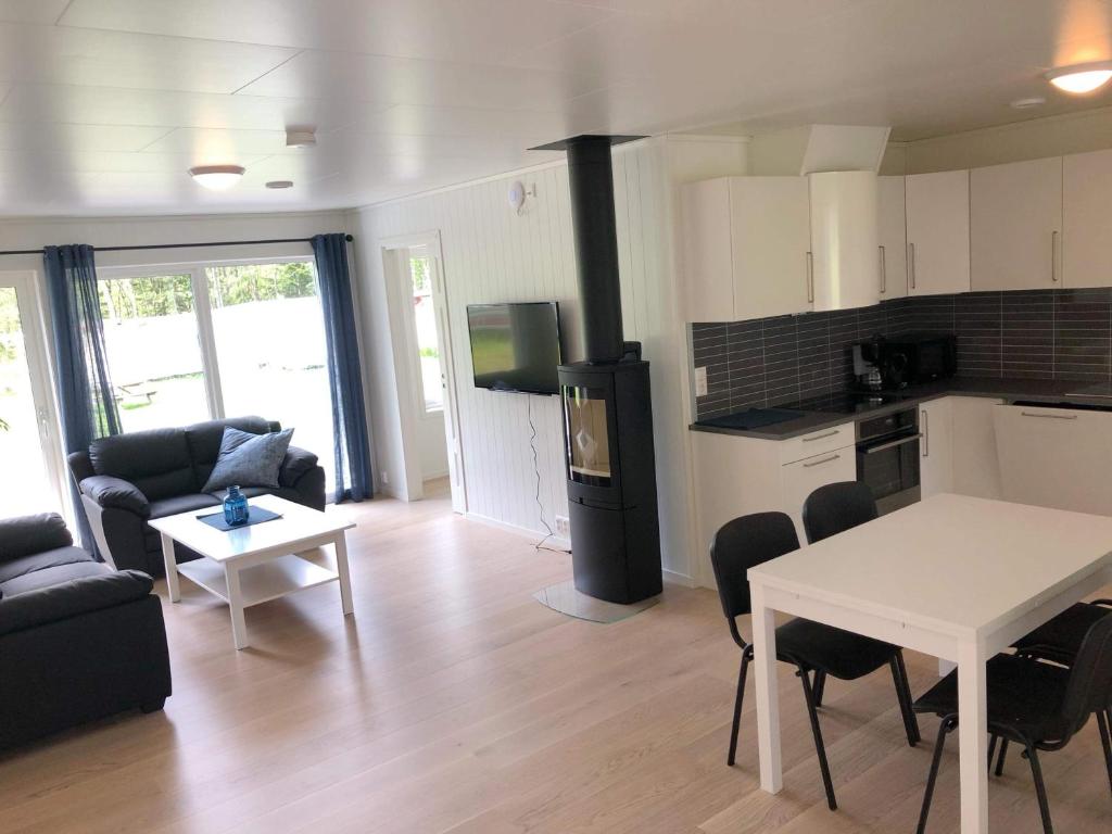 a kitchen and living room with a table and chairs at Saltvold leilighet nr1 in Røldal