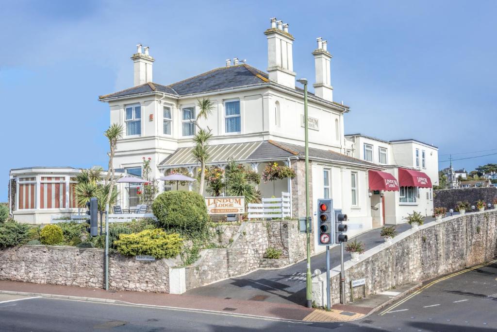 a large white house on a street with a traffic light at Lindum Lodge in Torquay