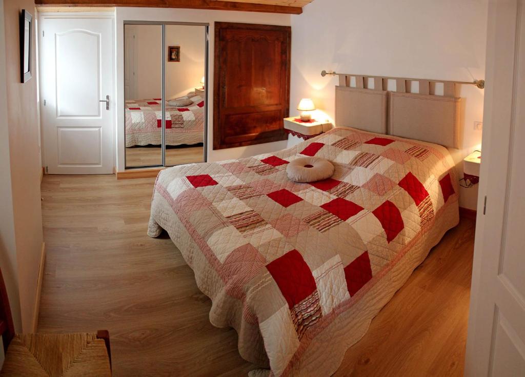 a bedroom with a bed with a teddy bear on it at Gîte Domaine Le Fragnaud in Saint-Porchaire