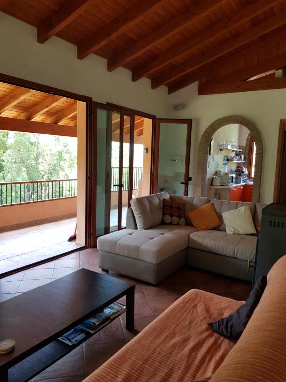 a living room with a couch and a table at Villa l'orto Portixeddu Sardegna in Fluminimaggiore