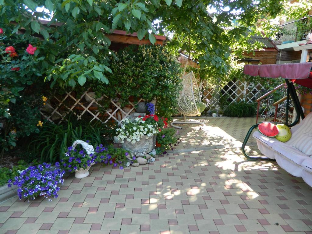 a garden with flowers and a bench and a fence at апартаменты на Ростовской 50 in Yeysk