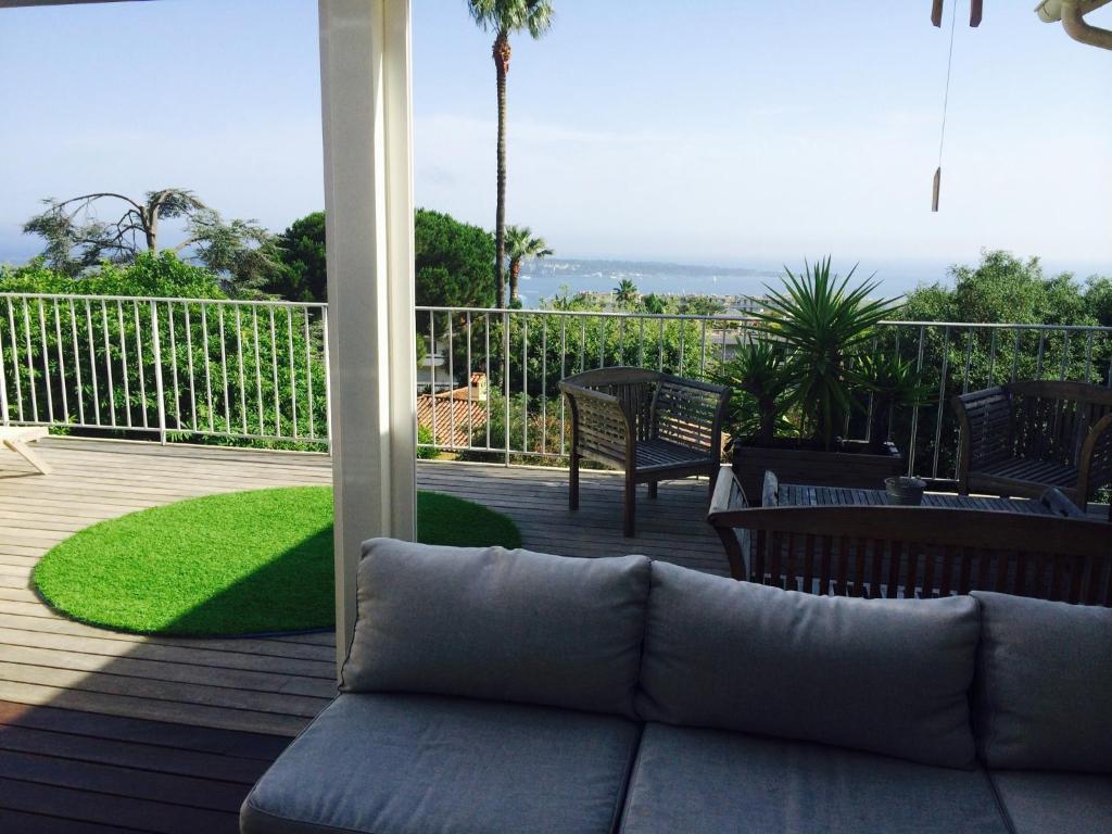 a couch on a deck with a view of the ocean at Rooftop grande terrasse jacuzzi vue mer in Cannes