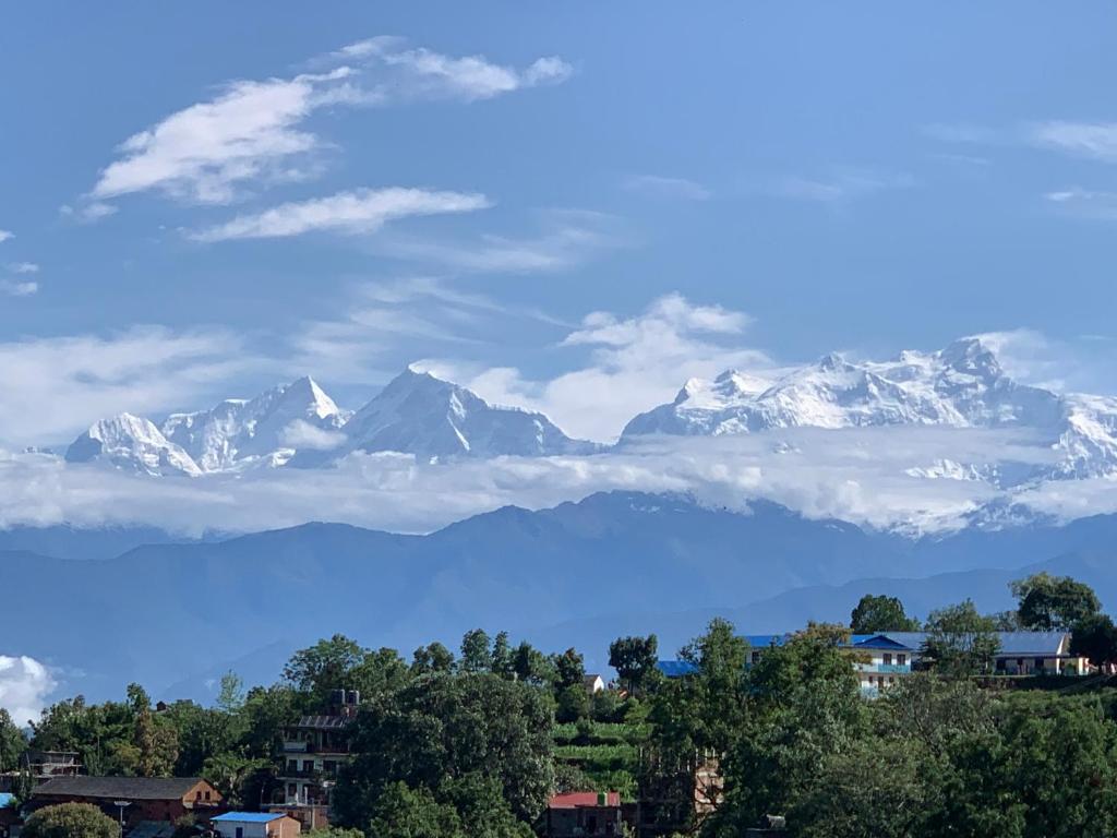 a view of snow capped mountains from a city at Bandipur Samira Homestay - Experience the Best for Less in Bandīpur