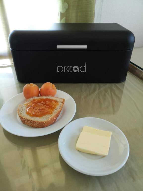 a plate of bread and a piece of cheese on a table at Dimitris Villa Hotel in Matala