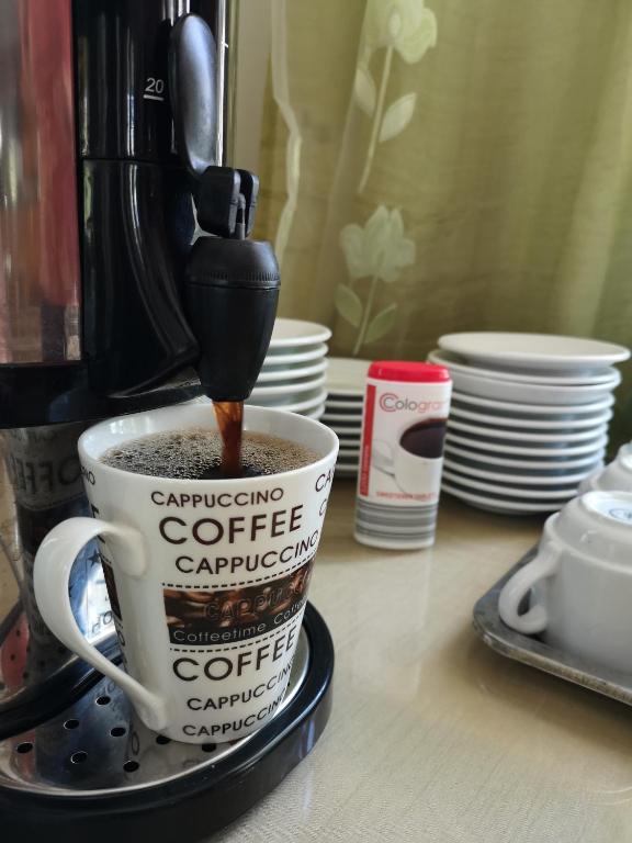 a coffee cup with coffee being poured into it at Dimitris Villa Hotel in Matala