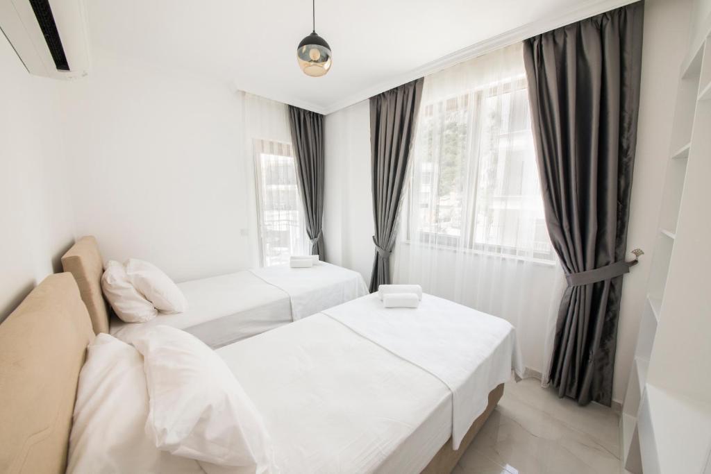 A bed or beds in a room at Cedrus Suites