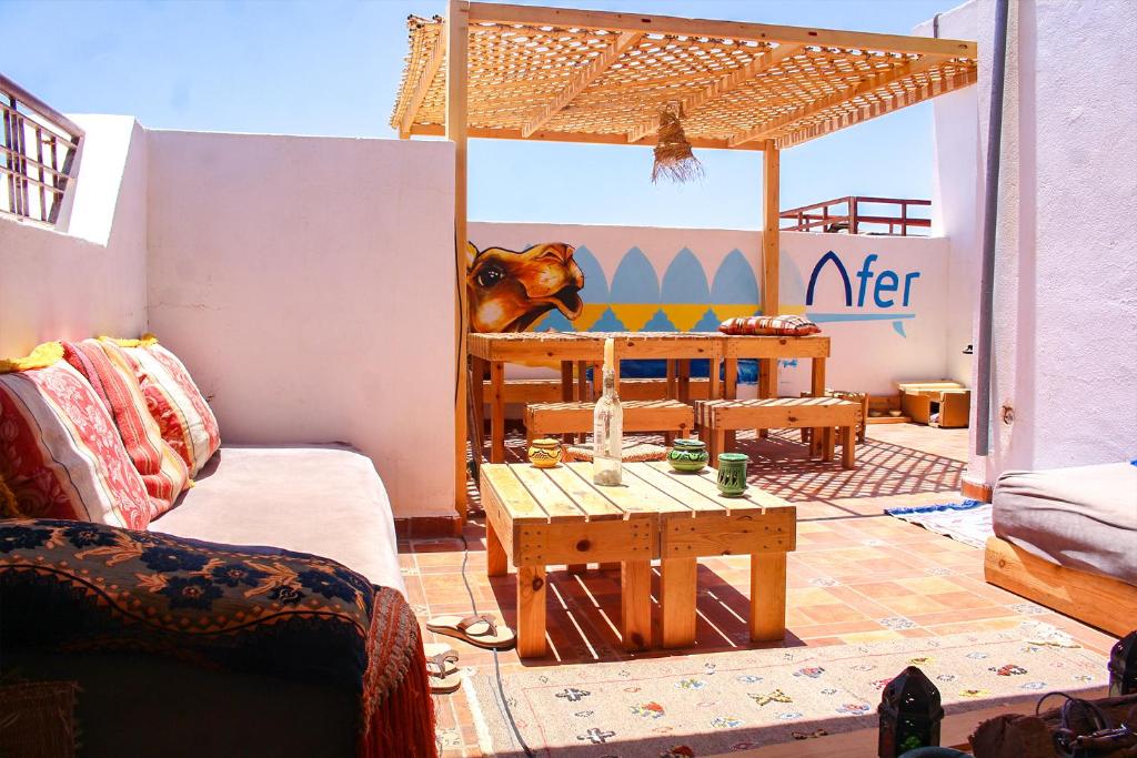 a living room with a couch and a table at Afer Surf Hostel in Imsouane