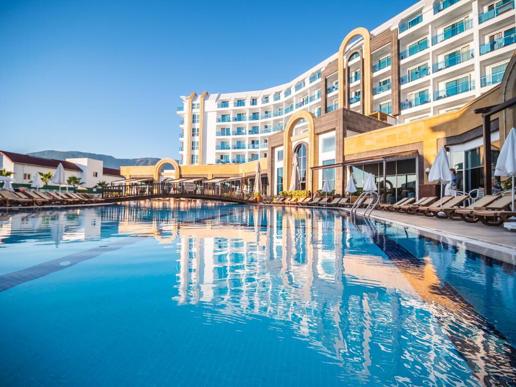 a swimming pool in front of a hotel at The Lumos Deluxe Resort Hotel & Spa in Kargicak