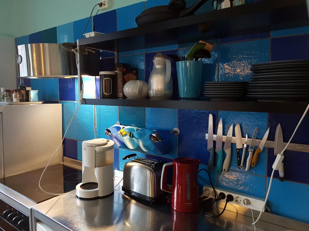 a kitchen with blue walls and a counter top at Low Budget in Bremen