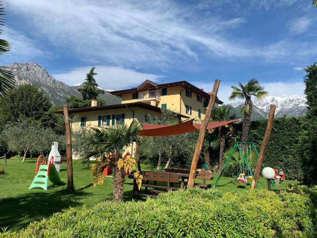 a playground in front of a house with a building at Agritur Girasole in Arco