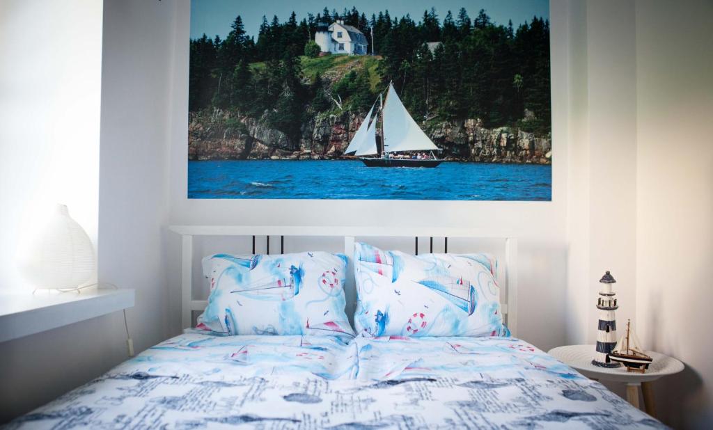 a bedroom with a bed with a sail boat on it at Apartament nad jeziorem Nidzkim in Ruciane-Nida