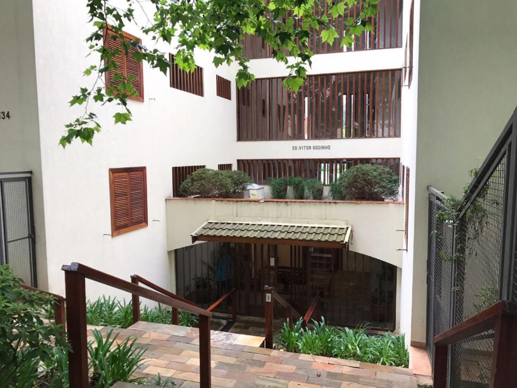 a building with a staircase in front of it at Apartamento no Centro de Campos do Jordao in Campos do Jordão