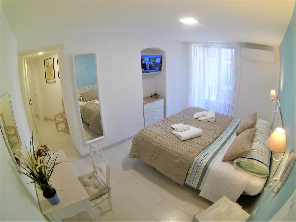 a bedroom with a bed and a large mirror at Landolina Sweet Home in Catania
