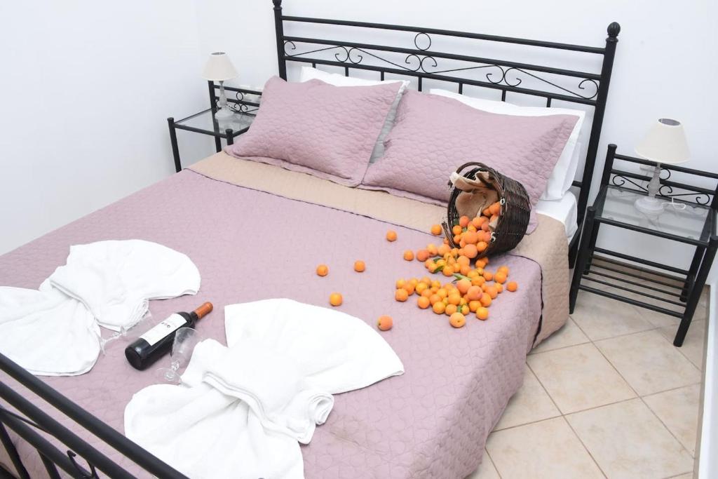 a bed with a bunch of fruit on it at Little Yard Studios & Apartments #3 in Naxos Chora