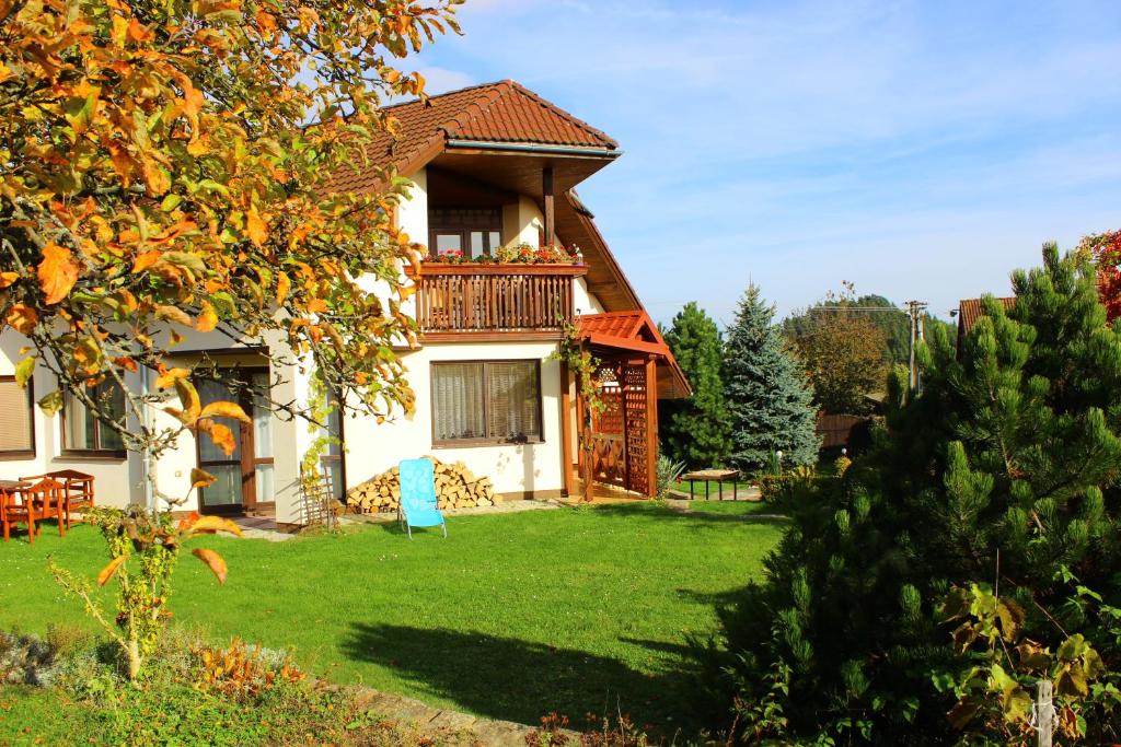 a house with a balcony and a yard at Clara Valis - Village House in Doľany