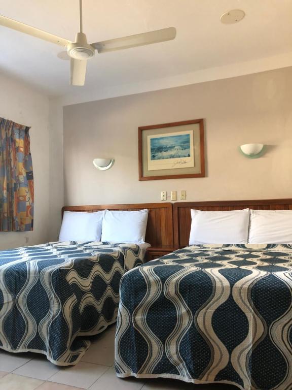 Postel nebo postele na pokoji v ubytování Hotel El Faro Malecon