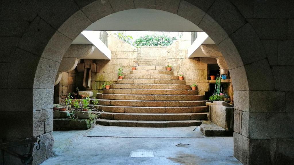 an archway with stairs in a building at Casa do Vale de Cerva in Cerva