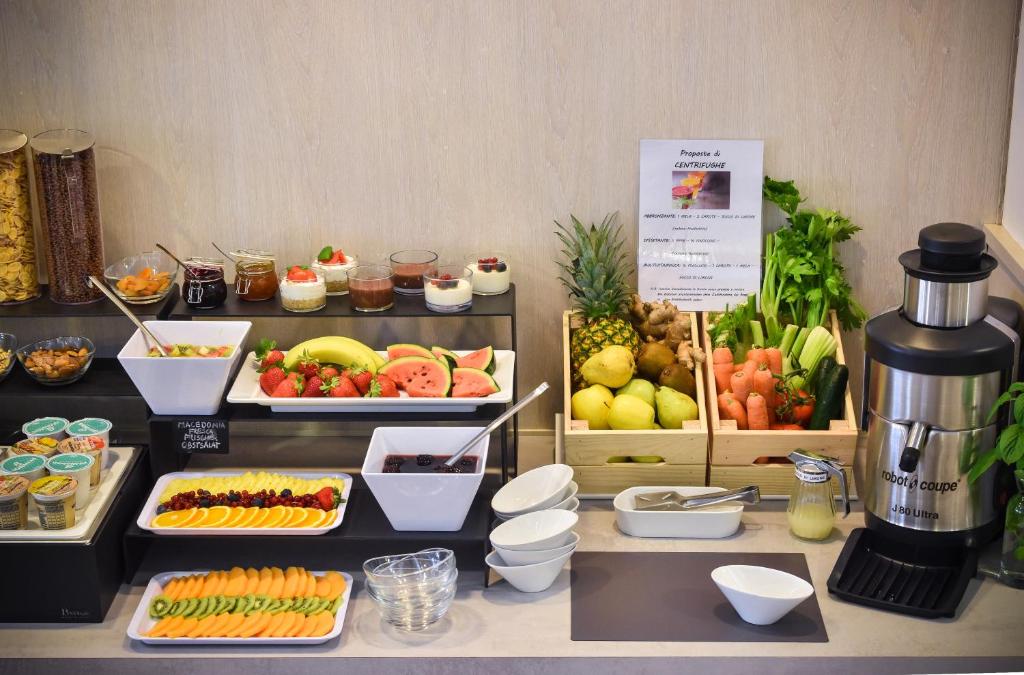 a buffet of food with fruits and vegetables on display at Hotel Lux in Caorle
