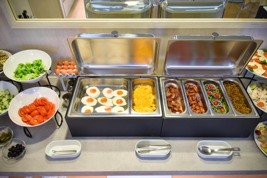 a buffet of food with eggs and other foods at Hotel Lux in Caorle