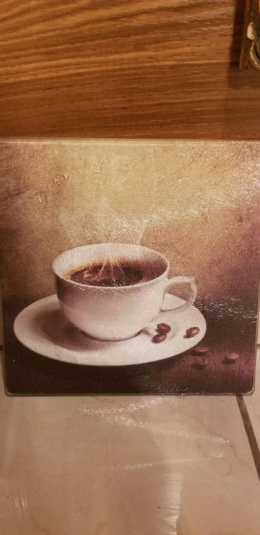 a painting of a cup of coffee on a plate at St. Anna's House in Squaw Valley