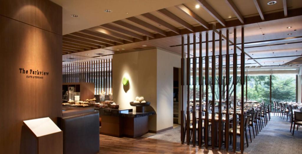 a restaurant with a bunch of tables and chairs at The Shilla Seoul in Seoul