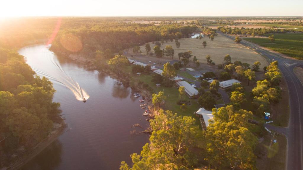 an aerial view of a river with trees and a road at Cadell On The Murray Motel in Moama