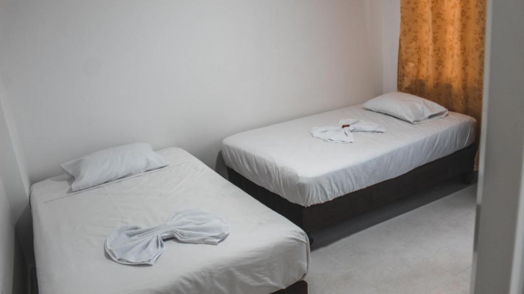 Postel nebo postele na pokoji v ubytování Hotel Palms Central