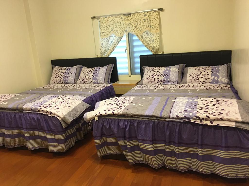 Postel nebo postele na pokoji v ubytování Hong Guo Homestay
