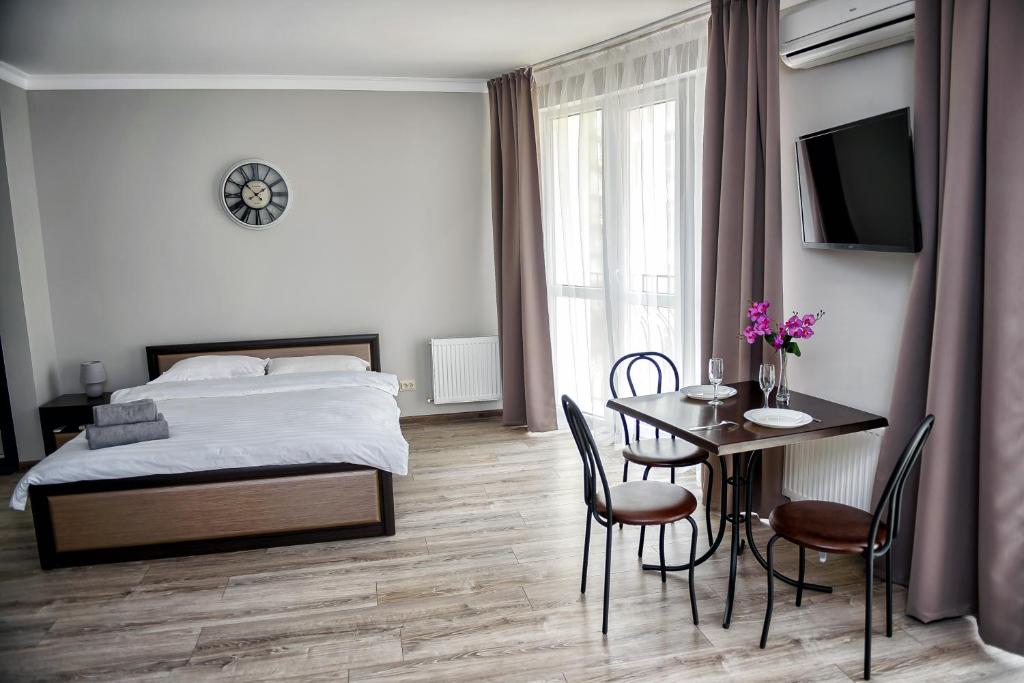 1 dormitorio con 1 cama, mesa y sillas en Apart Reserve Sloboda Loft en Ivano-Frankivsk