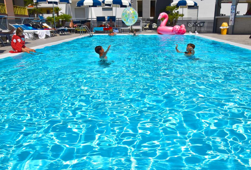 two children are swimming in a swimming pool at Hotel Bristol in Caorle
