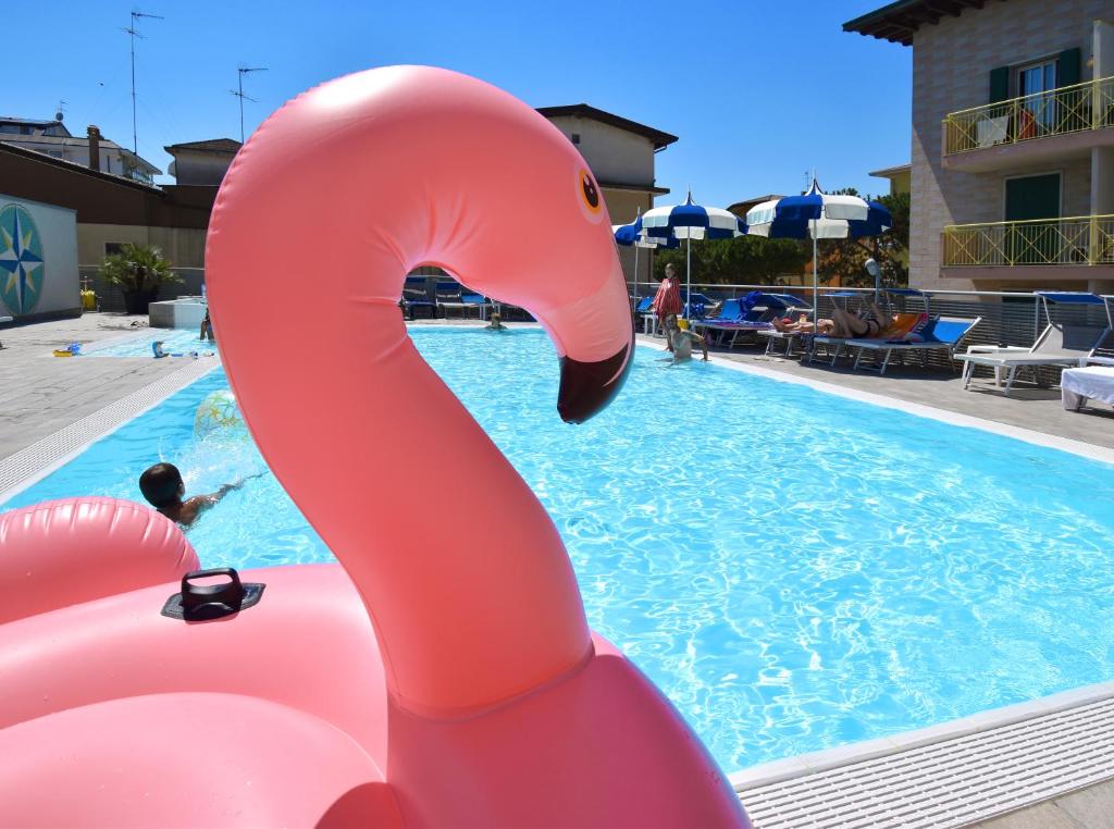 a pink inflatable swan in a swimming pool at Hotel Bristol in Caorle
