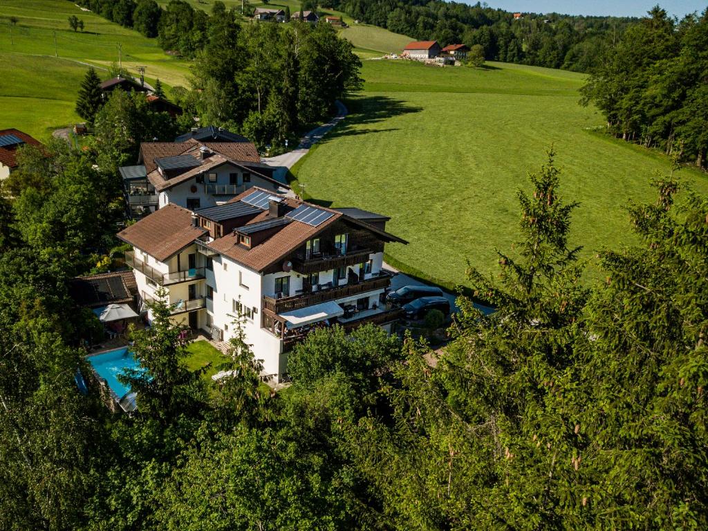an aerial view of a house in a green field at Pension Nocksteinblick in Salzburg