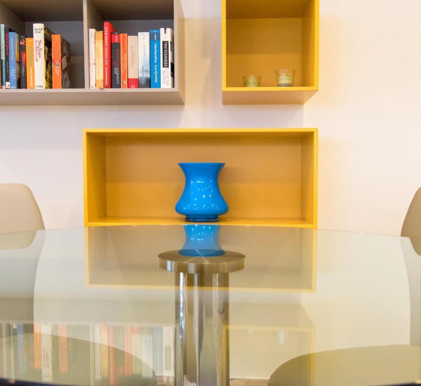 a blue vase sitting on top of a glass table at Hotel Bristol in Caorle