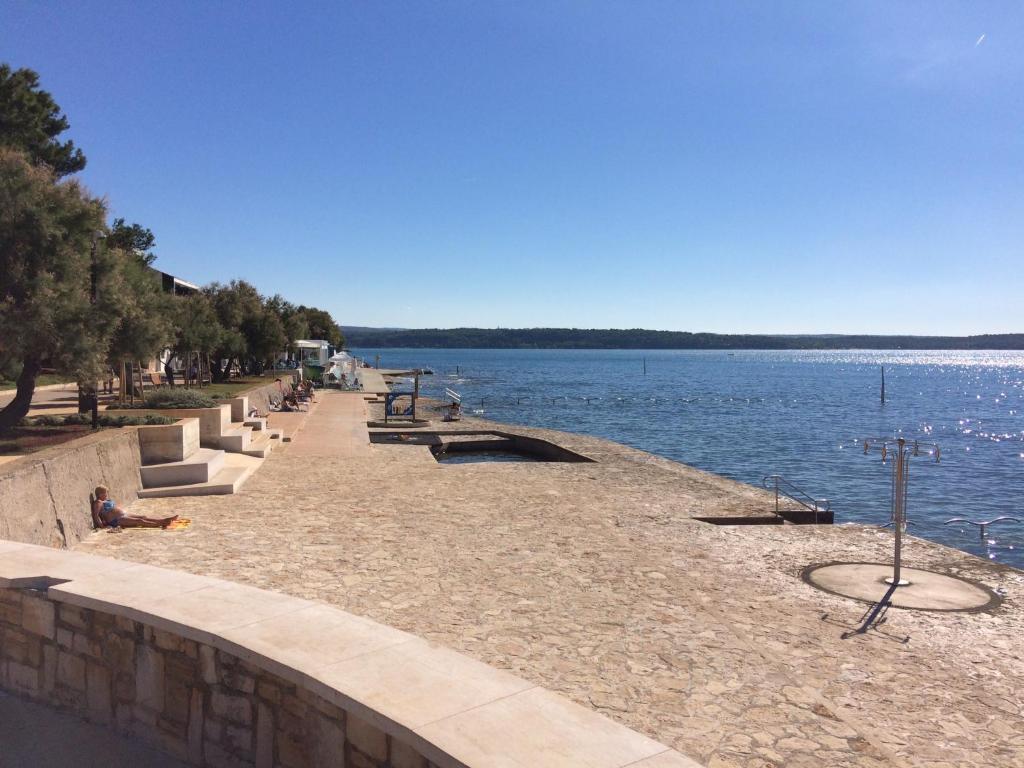 a walkway next to a body of water at Apartment Gio in Novigrad Istria