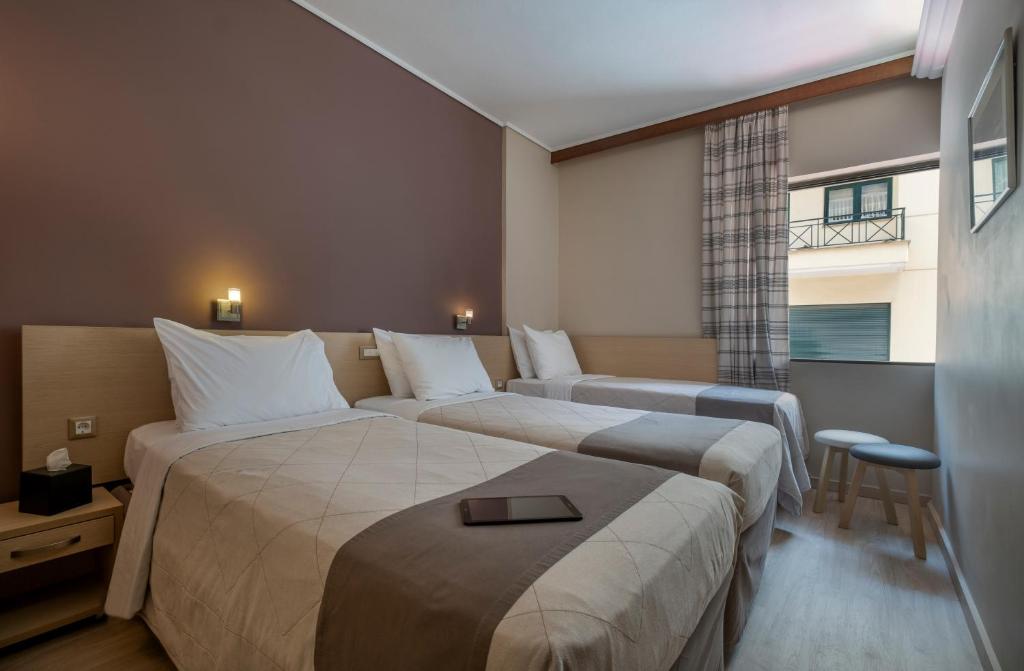 Postel nebo postele na pokoji v ubytování Acropolis View Hotel